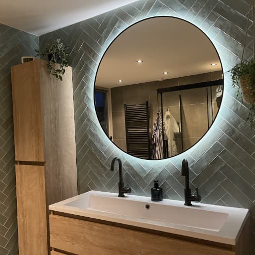 Mirror, furniture and tiles in the bathroom after DEYA Construction renovation in Haarlem